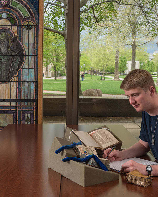 Luke Donahue viewing manuscripts from Rare Books and Special Collections at the Hesburgh Library