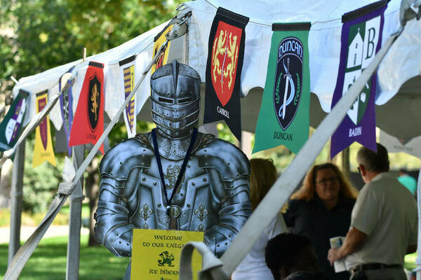 Image of knight and tailgate tent with banners at 2018 Medieval Institute tailgate