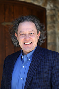 Headshot of David Menge in a blue shirt and jacket