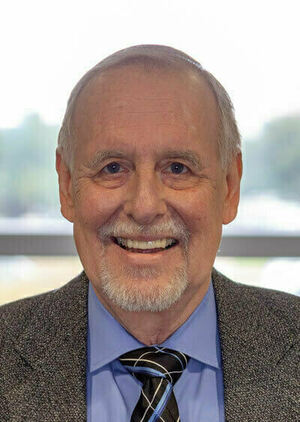 Headshot of man wearing suit